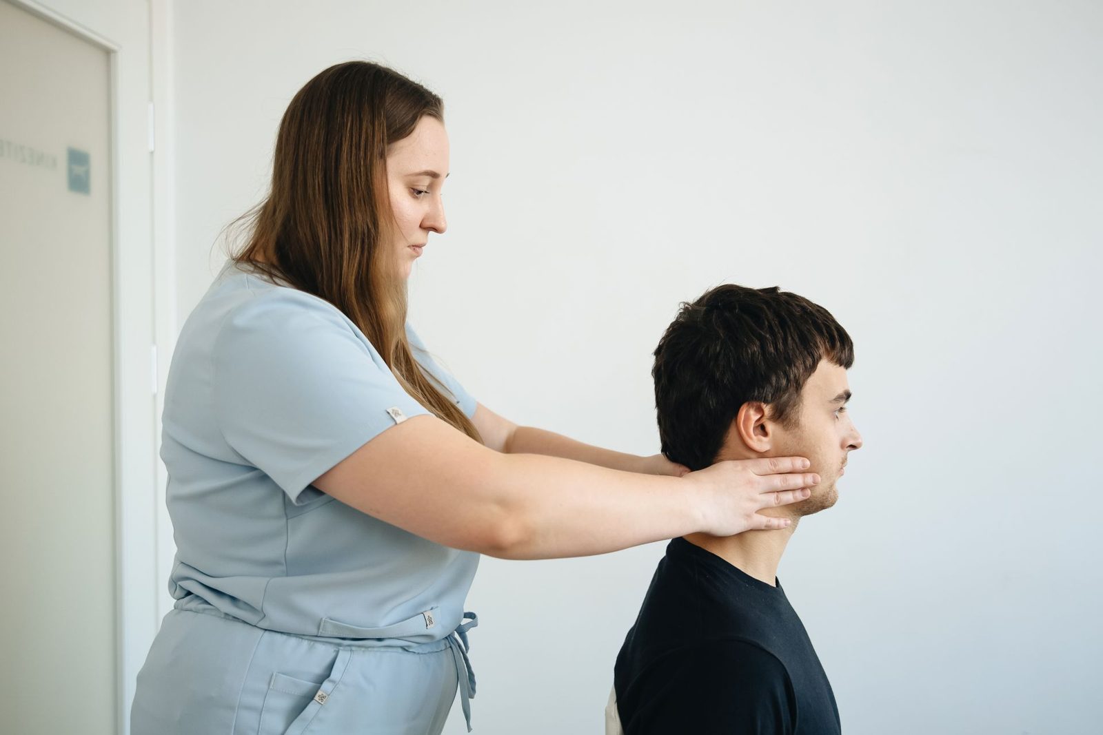 Physiotherapist treating a patient's neck